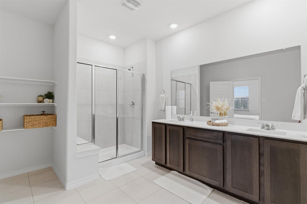 727 Fort Lane Fate, TX 75189 - Photo 11 of 19 a bathroom with a double vanity sink and mirror