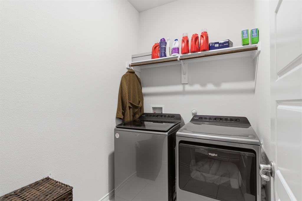 727 Fort Lane Fate, TX 75189 - Photo 12 of 19 a kitchen with a stove and a microwave