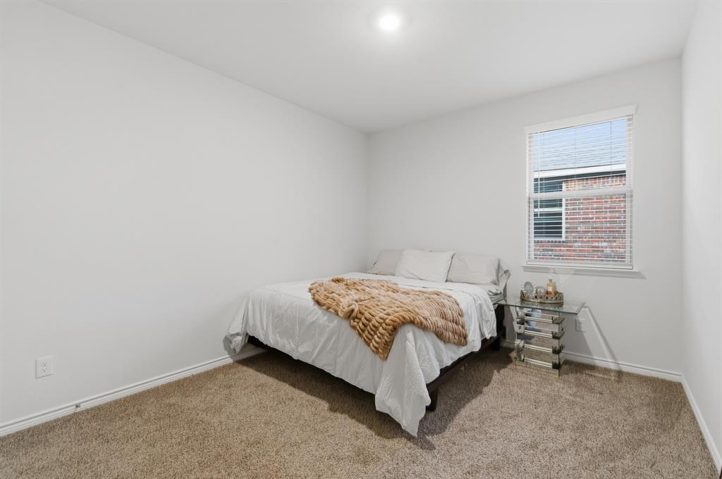 727 Fort Lane Fate, TX 75189 - Photo 15 of 19 a bed sitting in a bedroom next to a window