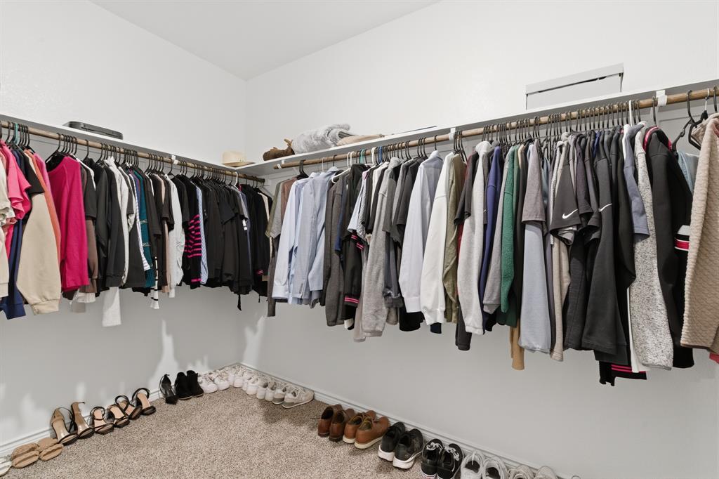 727 Fort Lane Fate, TX 75189 - Photo 16 of 19 a view of walk in closet with clothes
