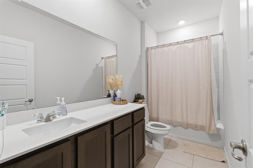 727 Fort Lane Fate, TX 75189 - Photo 18 of 19 a bathroom with a double vanity sink toilet and a mirror