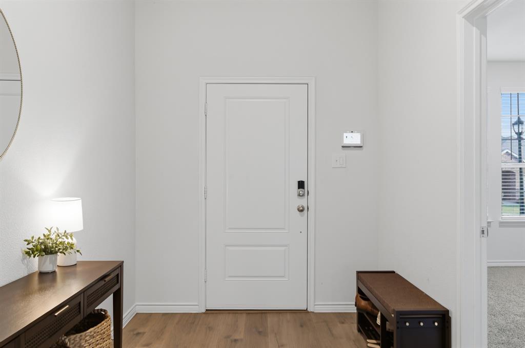 727 Fort Lane Fate, TX 75189 - Photo 2 of 19 a view of room with a potted plant on a table and chair