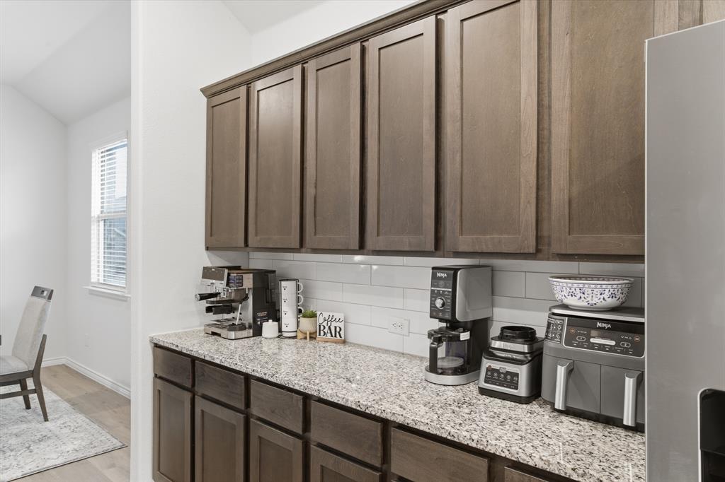 727 Fort Lane Fate, TX 75189 - Photo 10 of 19 a kitchen with stainless steel appliances granite countertop a sink window and cabinets