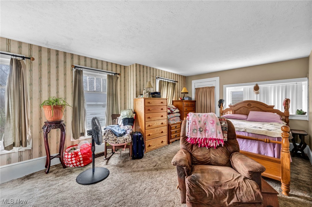 34 Old State Road North Norwalk, OH 44857 - Photo 23 of 31 Carpeted bedroom featuring a textured ceiling and wallpapered walls