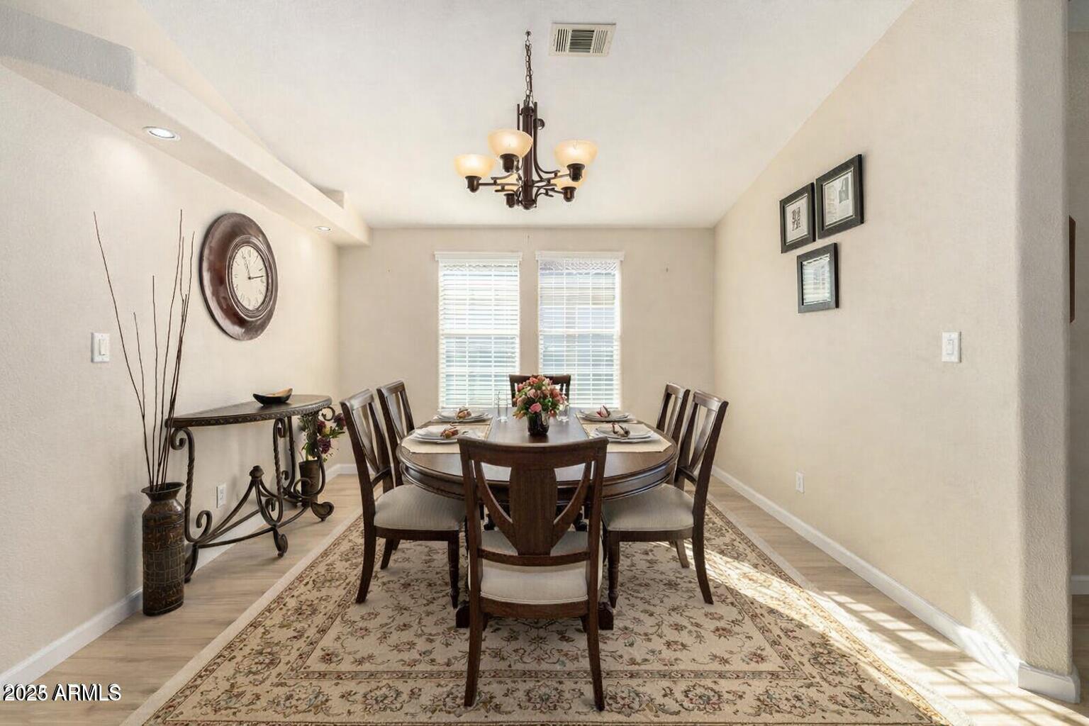 3301 South Goldfield Road, Unit 4018 Apache Junction, AZ 85119 - Photo 21 of 45 a view of a dining room with furniture window and wooden floor