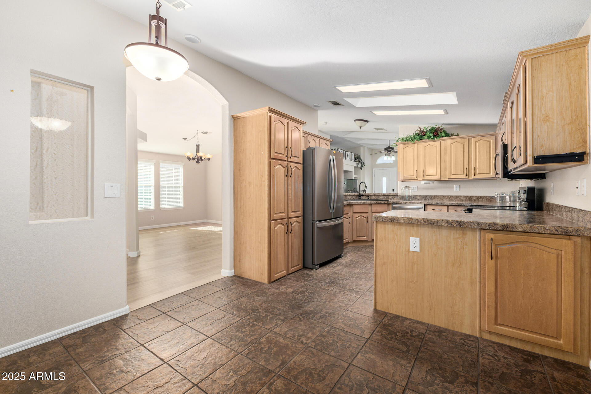 3301 South Goldfield Road, Unit 4018 Apache Junction, AZ 85119 - Photo 24 of 45 a kitchen with stainless steel appliances granite countertop a refrigerator and a stove top oven