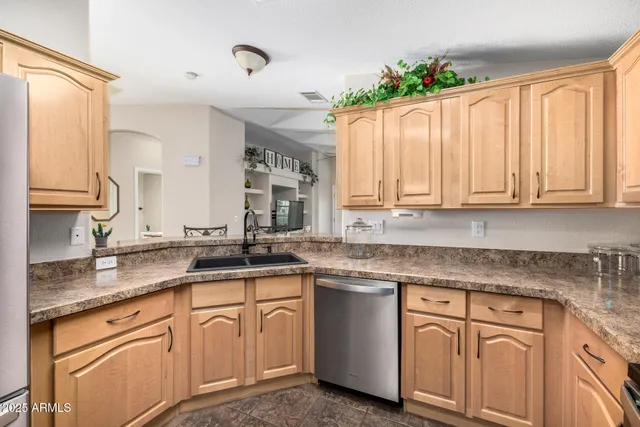 a kitchen with granite countertop white cabinets white appliances and a sink
