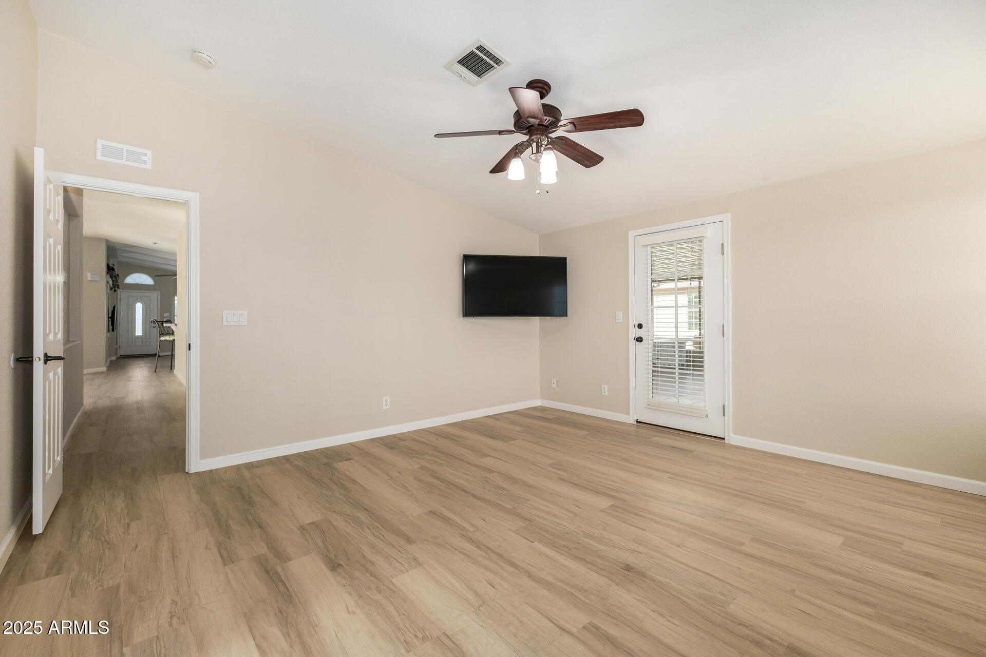 3301 South Goldfield Road, Unit 4018 Apache Junction, AZ 85119 - Photo 29 of 45 a view of empty room with wooden floor and fan