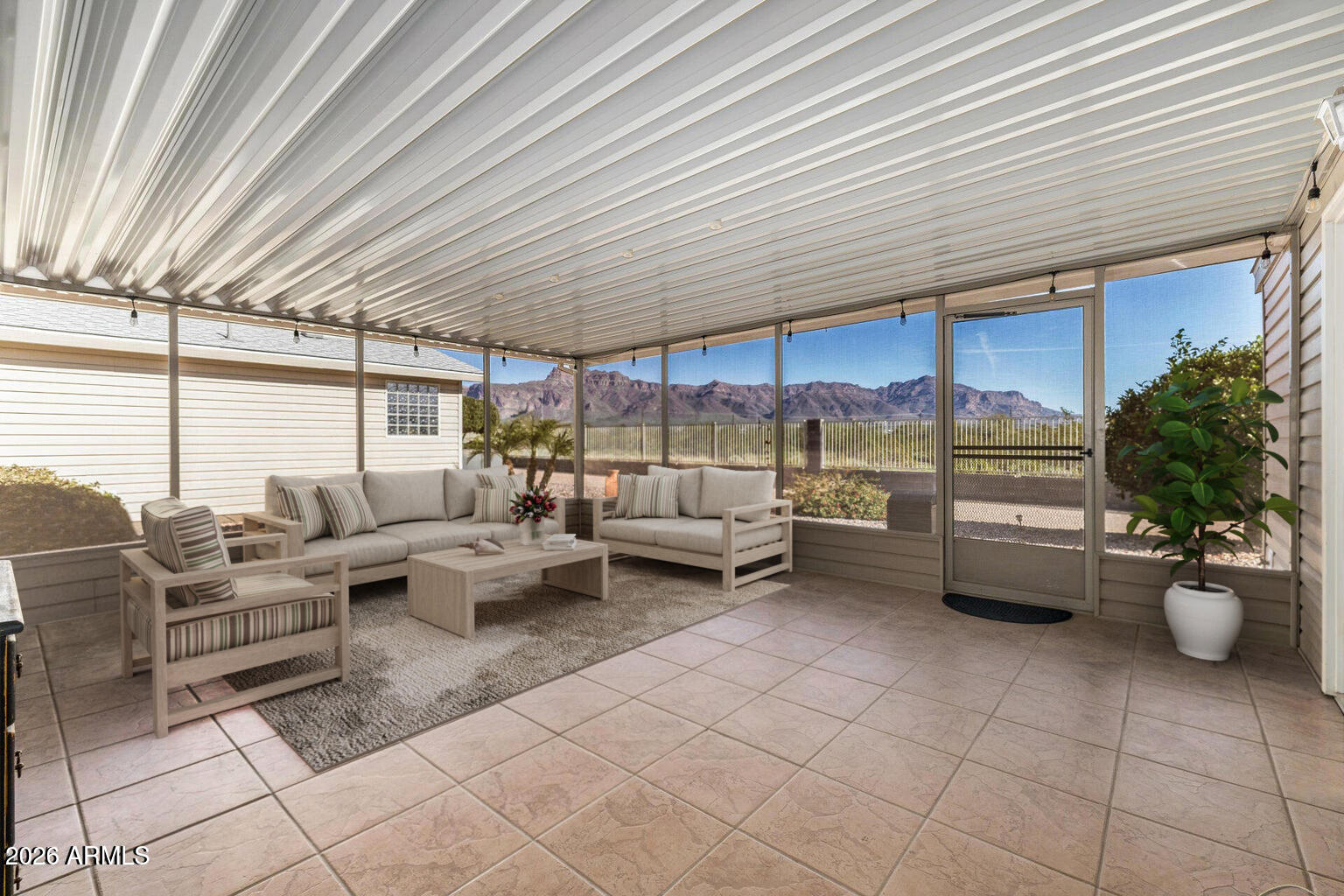 3301 South Goldfield Road, Unit 4018 Apache Junction, AZ 85119 - Photo 4 of 45 a living room with furniture and a potted plant