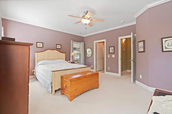 a bedroom with a large bed and a chandelier