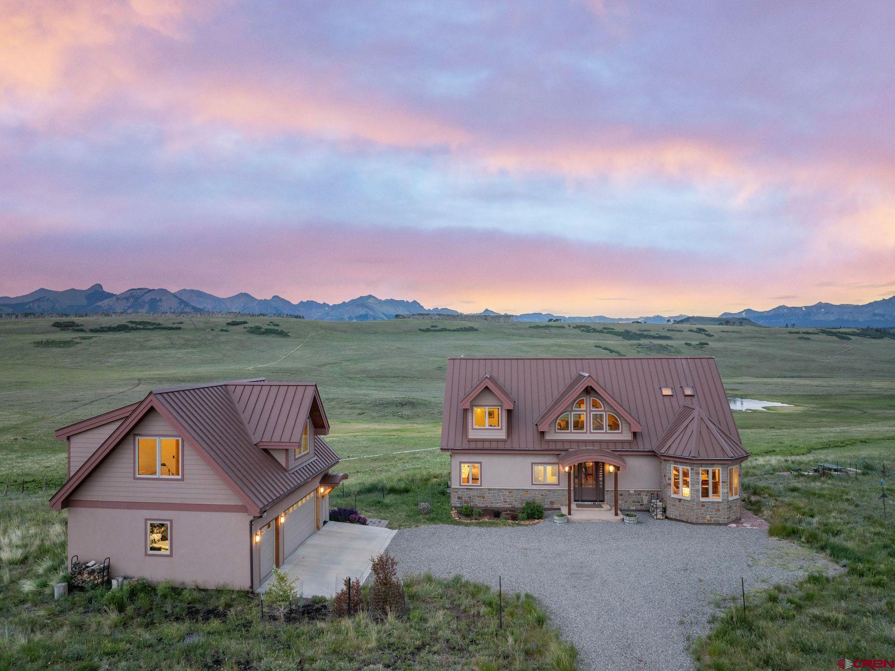an aerial view of a house with outdoor space and lake view
