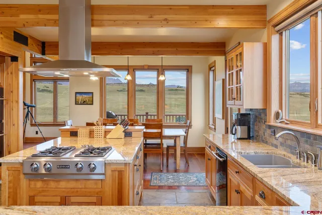 a kitchen with granite countertop a stove a sink and a counter space