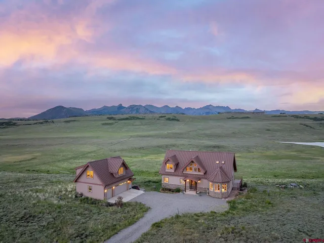 a living room with furniture and large windows