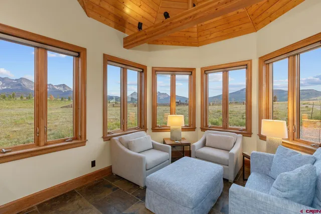 a living room with furniture and stairs