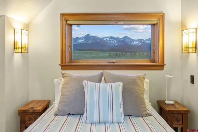 a work room with furniture and large windows