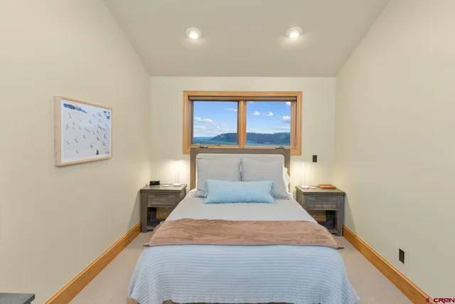 a bathroom with a granite countertop sink and a window