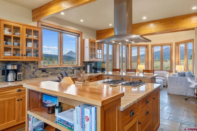 a very nice looking dining room with a large dining table and chairs with wooden floor
