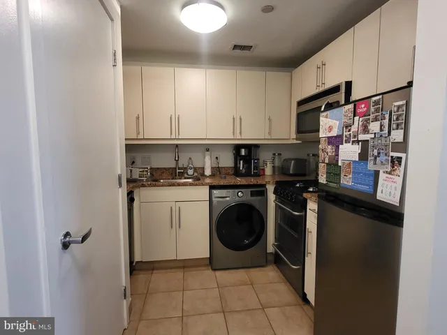 a kitchen with a refrigerator and cabinets