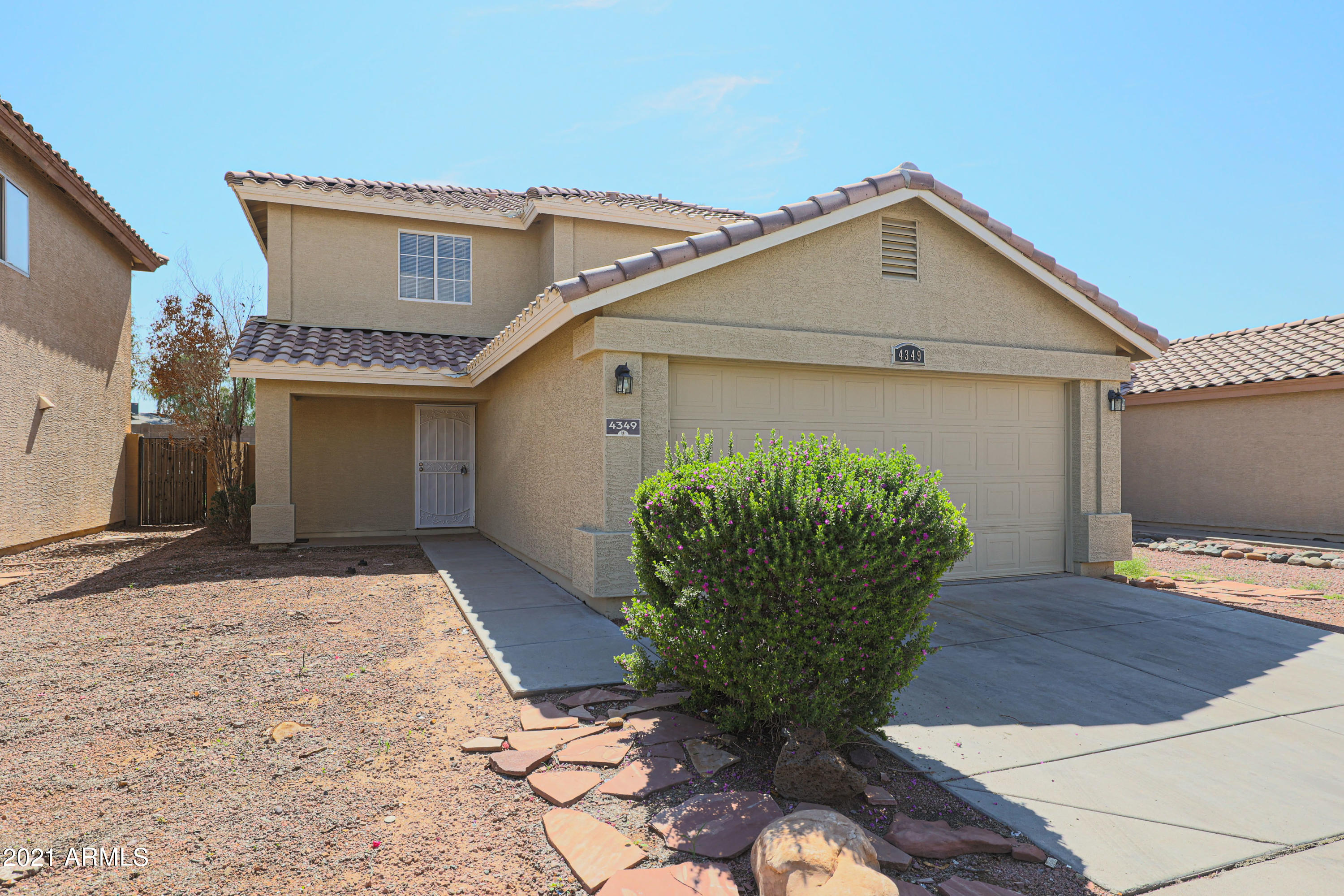 4349 North 111th Lane Phoenix, AZ 85037 - Photo 1 of 18 a front view of a house with garden