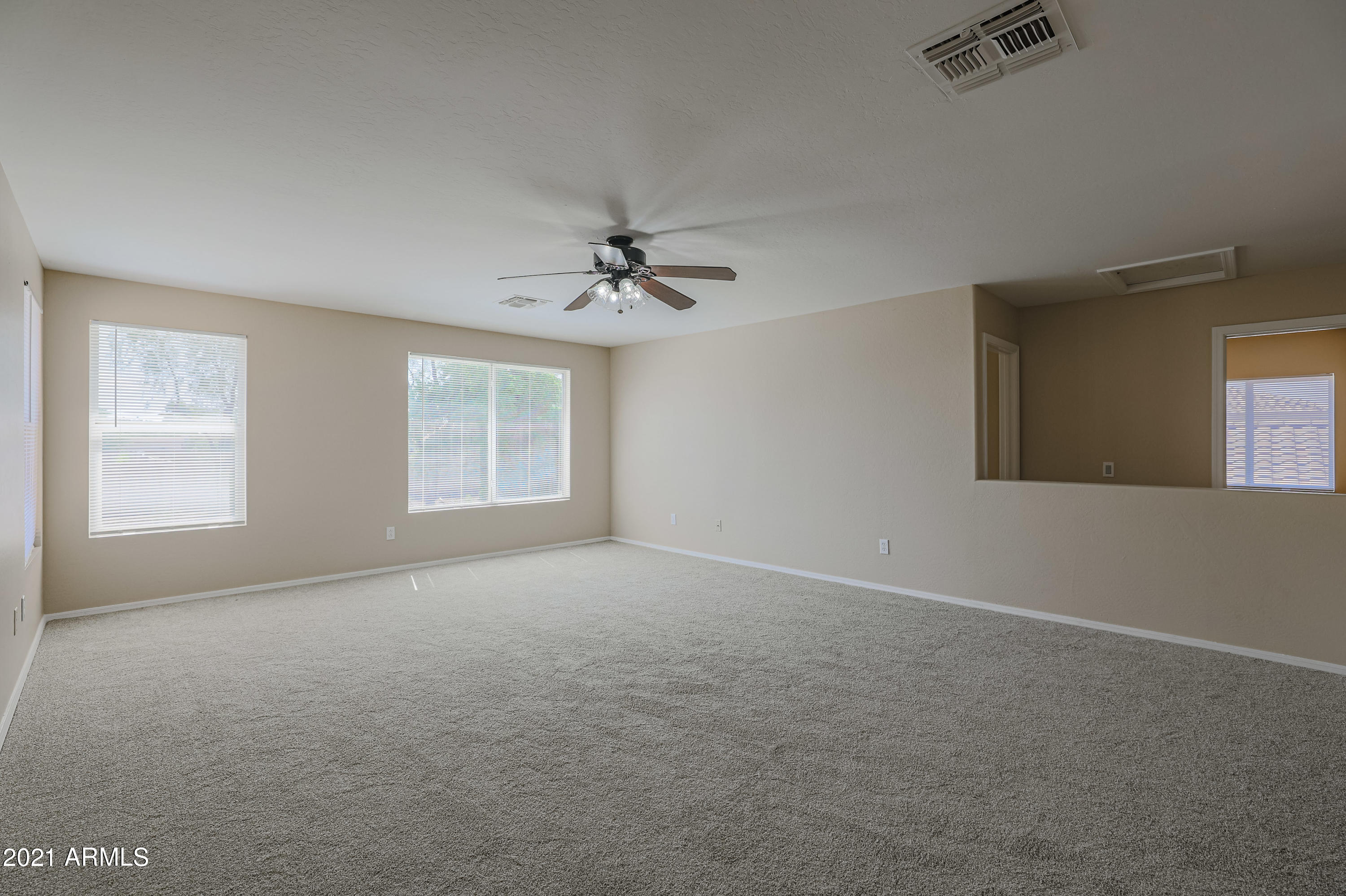 4349 North 111th Lane Phoenix, AZ 85037 - Photo 12 of 18 a view of an empty room with a window