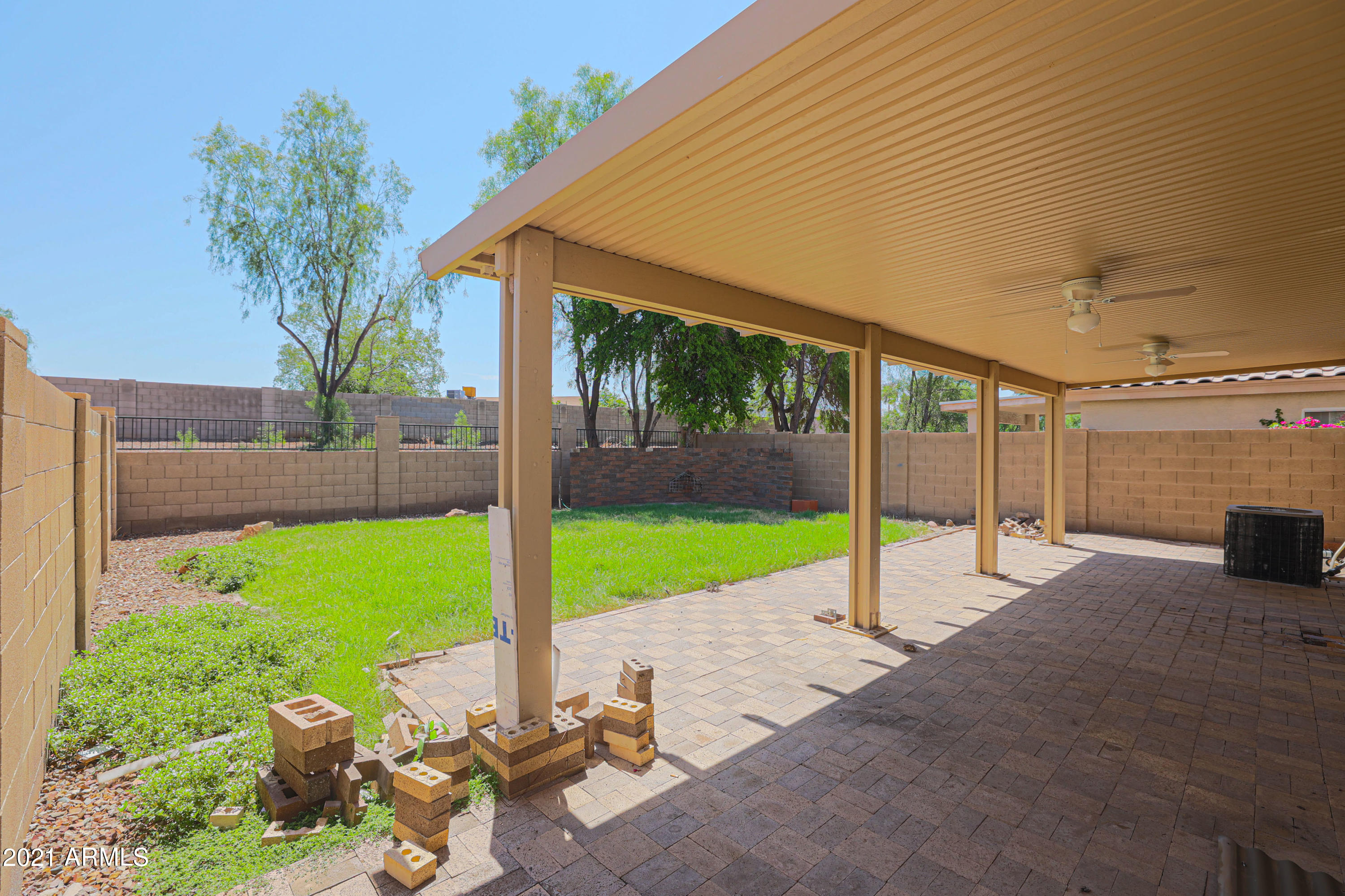 4349 North 111th Lane Phoenix, AZ 85037 - Photo 16 of 18 a view of a backyard with garden