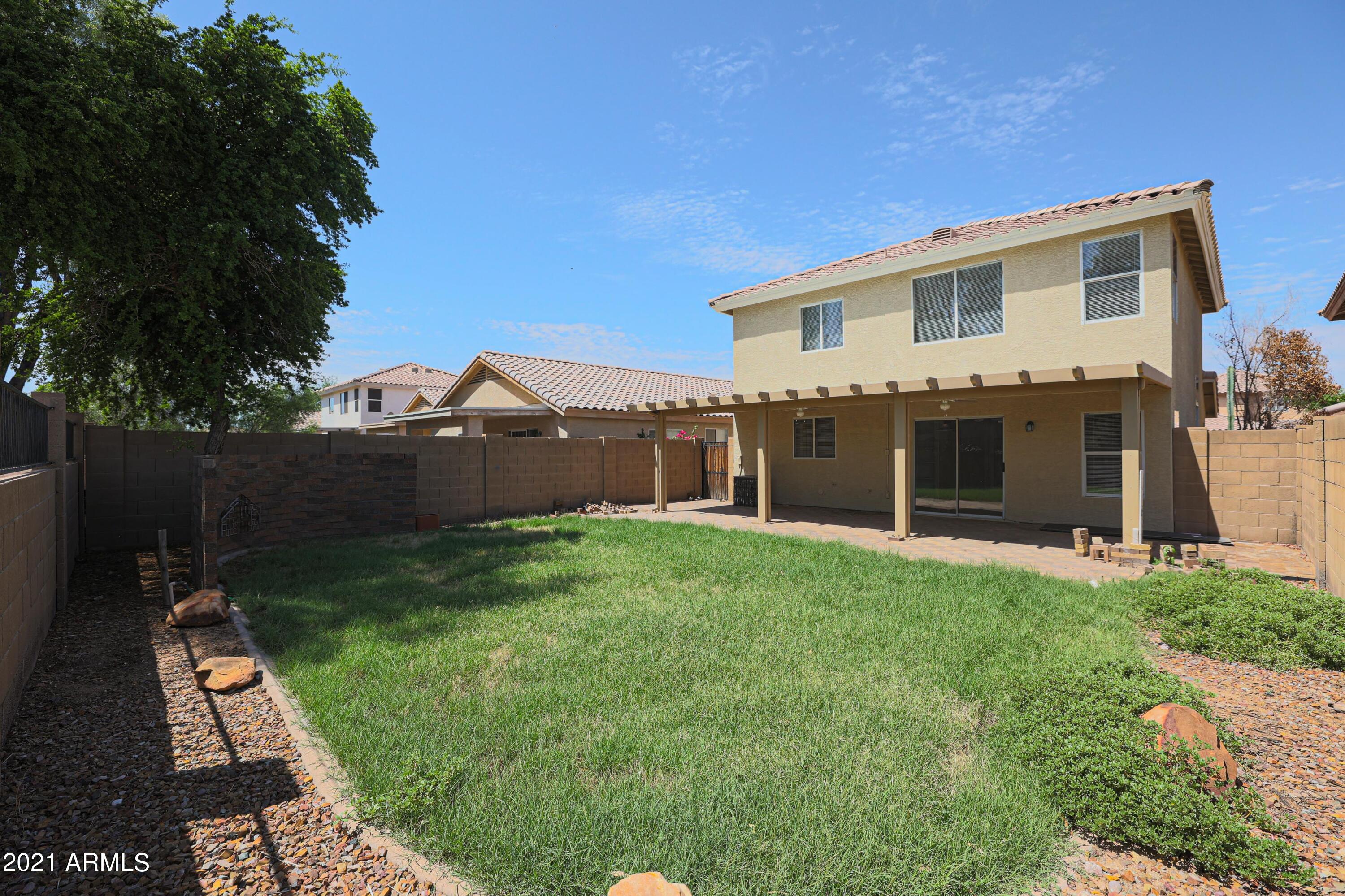 4349 North 111th Lane Phoenix, AZ 85037 - Photo 17 of 18 front view of a house with a yard