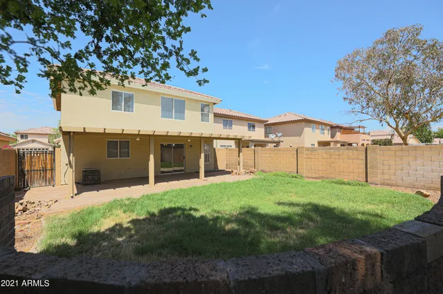 a view of a yard with a house and a large tree
