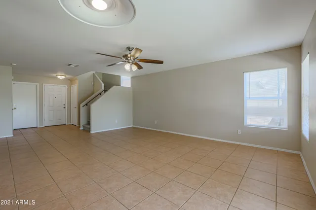 a view of a livingroom with a ceiling fan and window