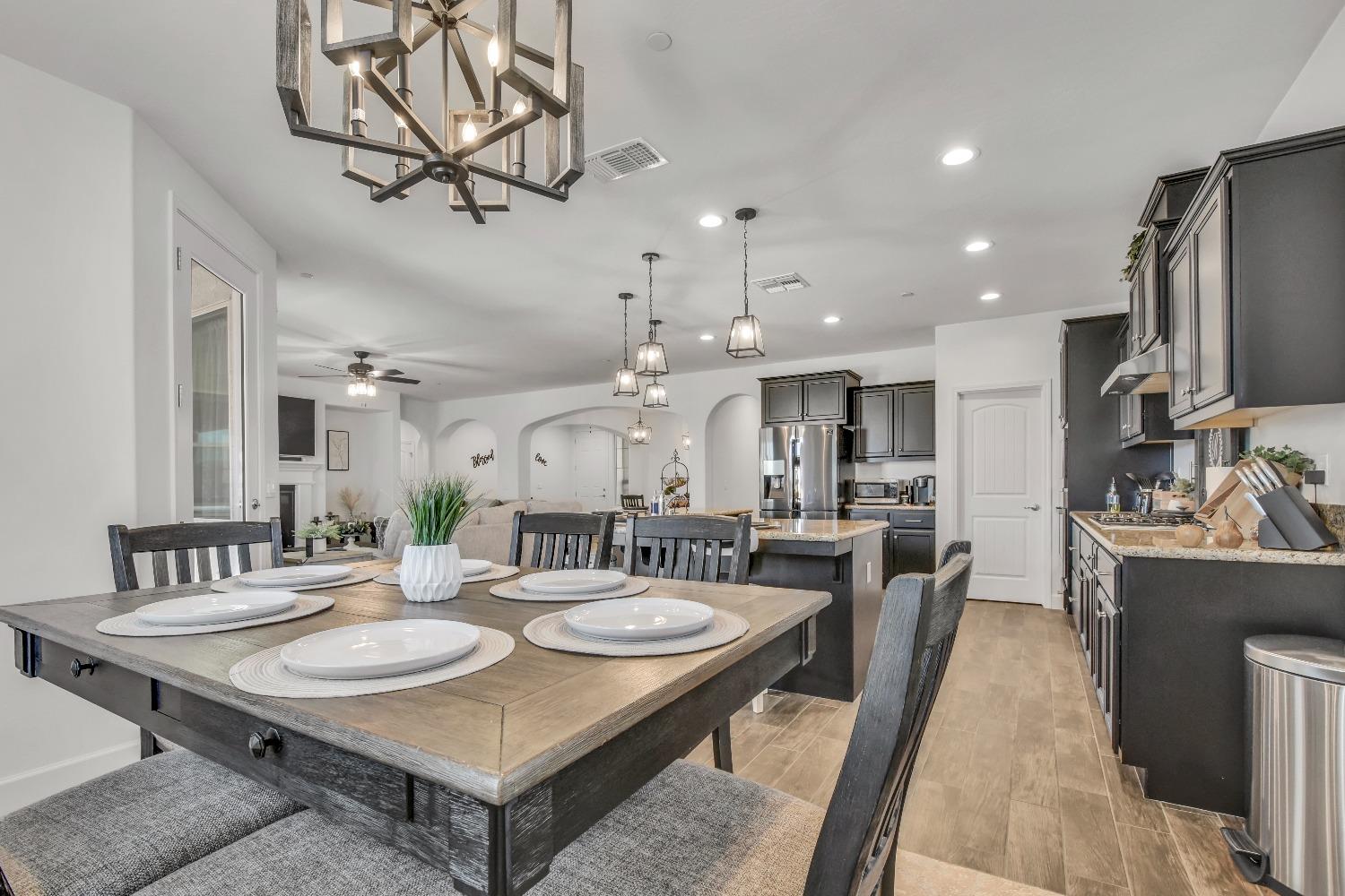 400 Ridge Creek Estates Way Dinuba, CA 93618 - Photo 13 of 49 a large kitchen with a table and chairs
