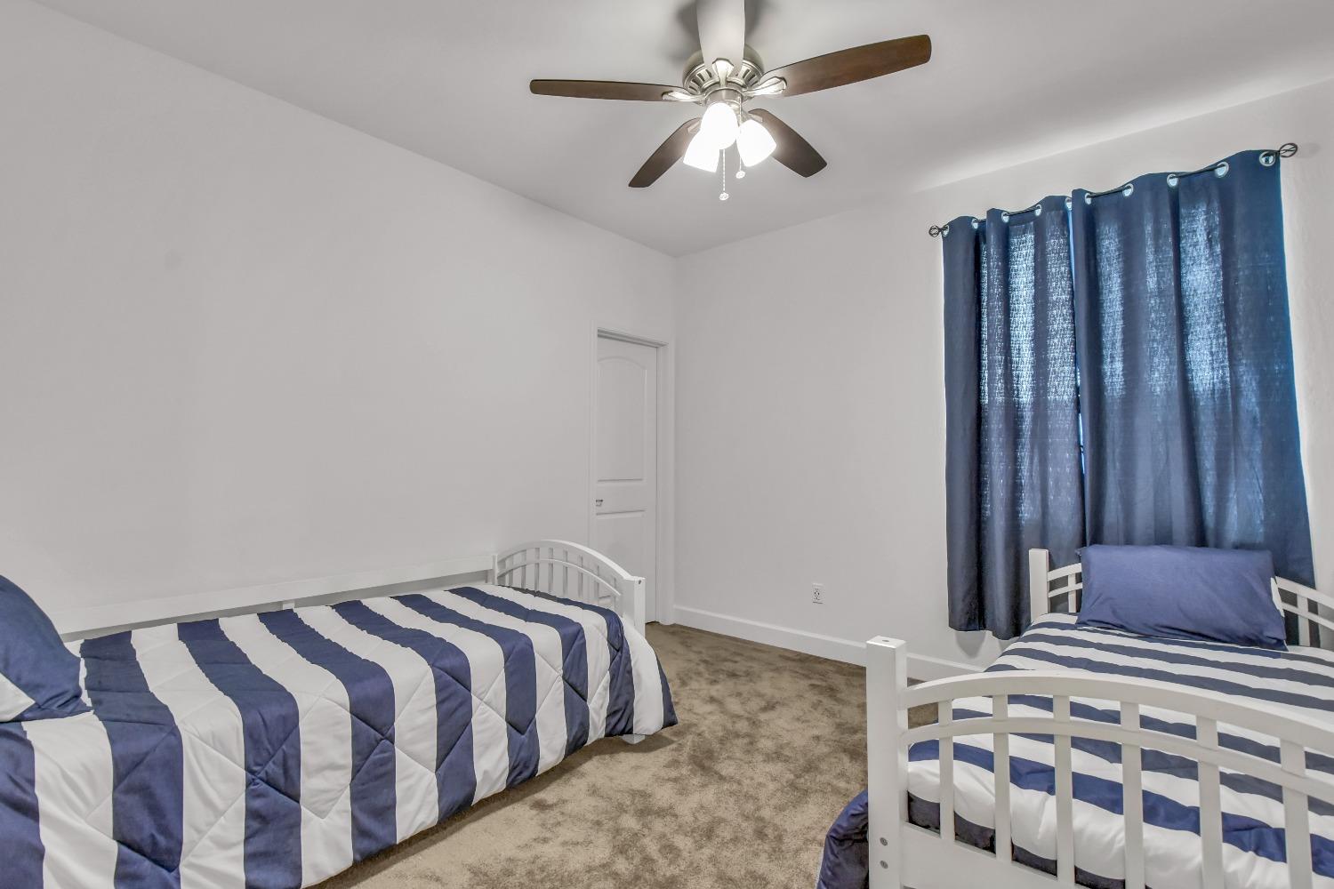 400 Ridge Creek Estates Way Dinuba, CA 93618 - Photo 19 of 49 a bedroom with a bed and wooden floor