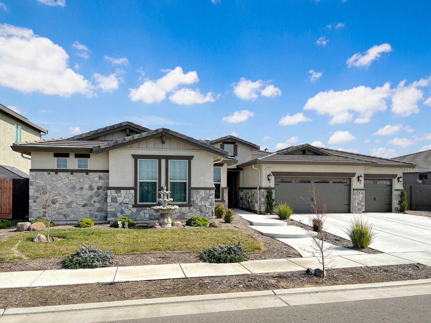 400 Ridge Creek Estates Way Dinuba, CA 93618 - Photo 2 of 49 a front view of a house with a yard