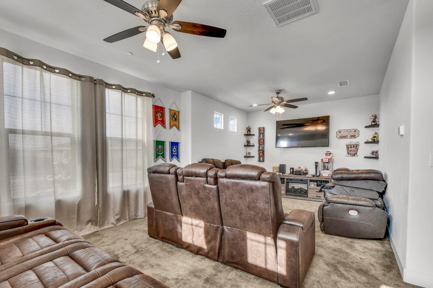 400 Ridge Creek Estates Way Dinuba, CA 93618 - Photo 24 of 49 a living room with furniture a flat screen tv and a window