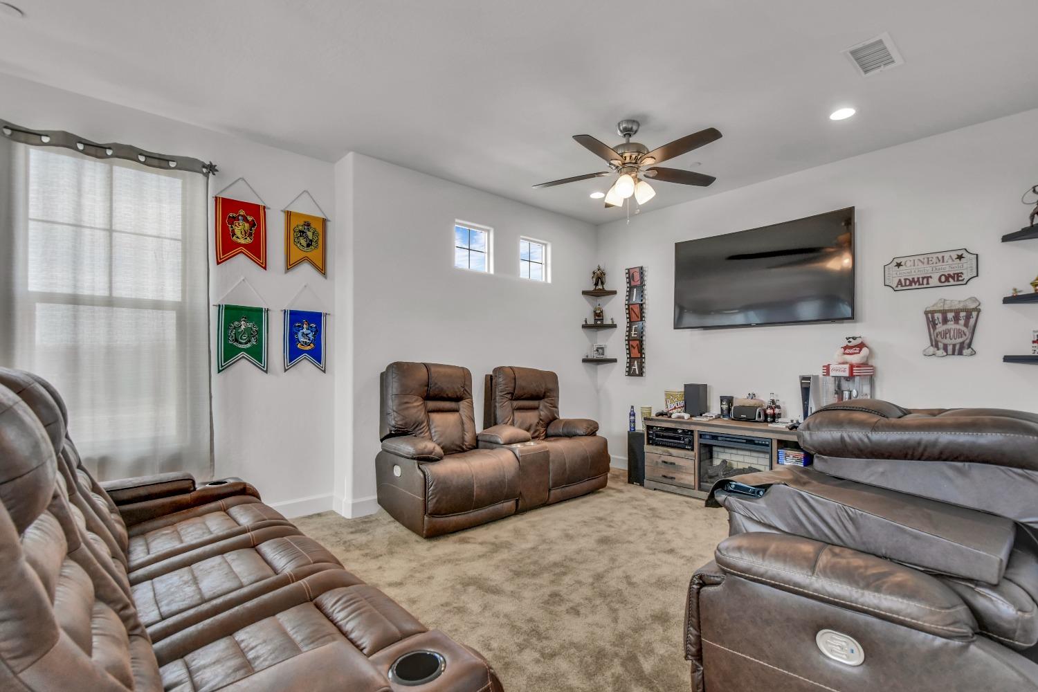 400 Ridge Creek Estates Way Dinuba, CA 93618 - Photo 26 of 49 a living room with furniture and a flat screen tv