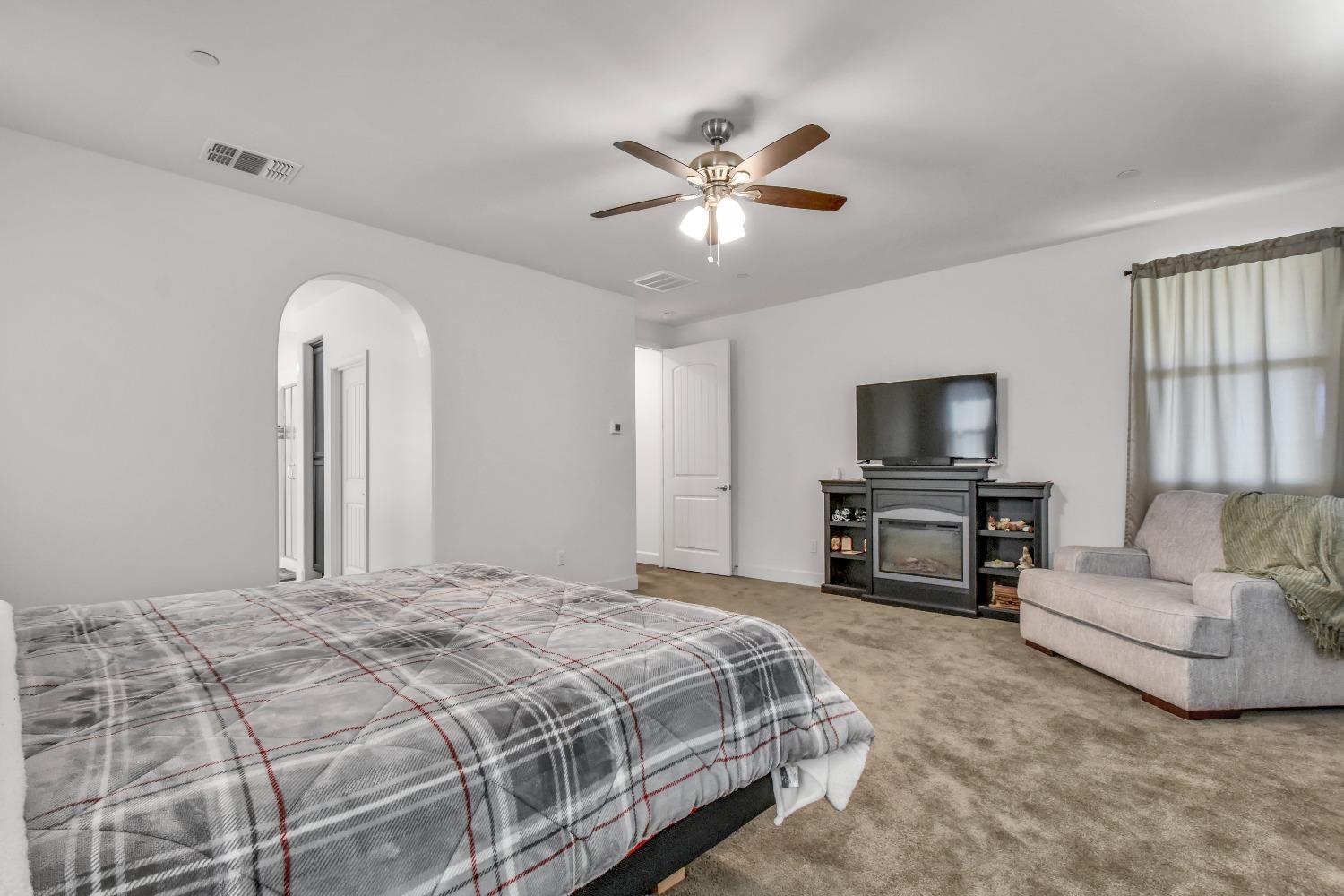 400 Ridge Creek Estates Way Dinuba, CA 93618 - Photo 29 of 49 a bedroom with a bed and a flat screen tv