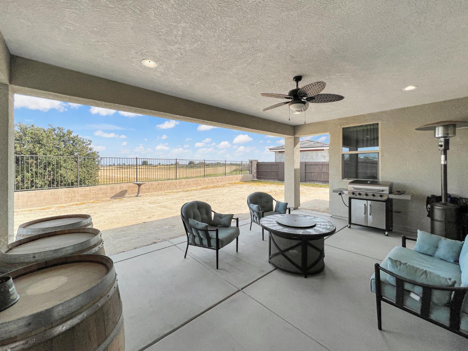 400 Ridge Creek Estates Way Dinuba, CA 93618 - Photo 36 of 49 a living room with patio furniture and a floor to ceiling window