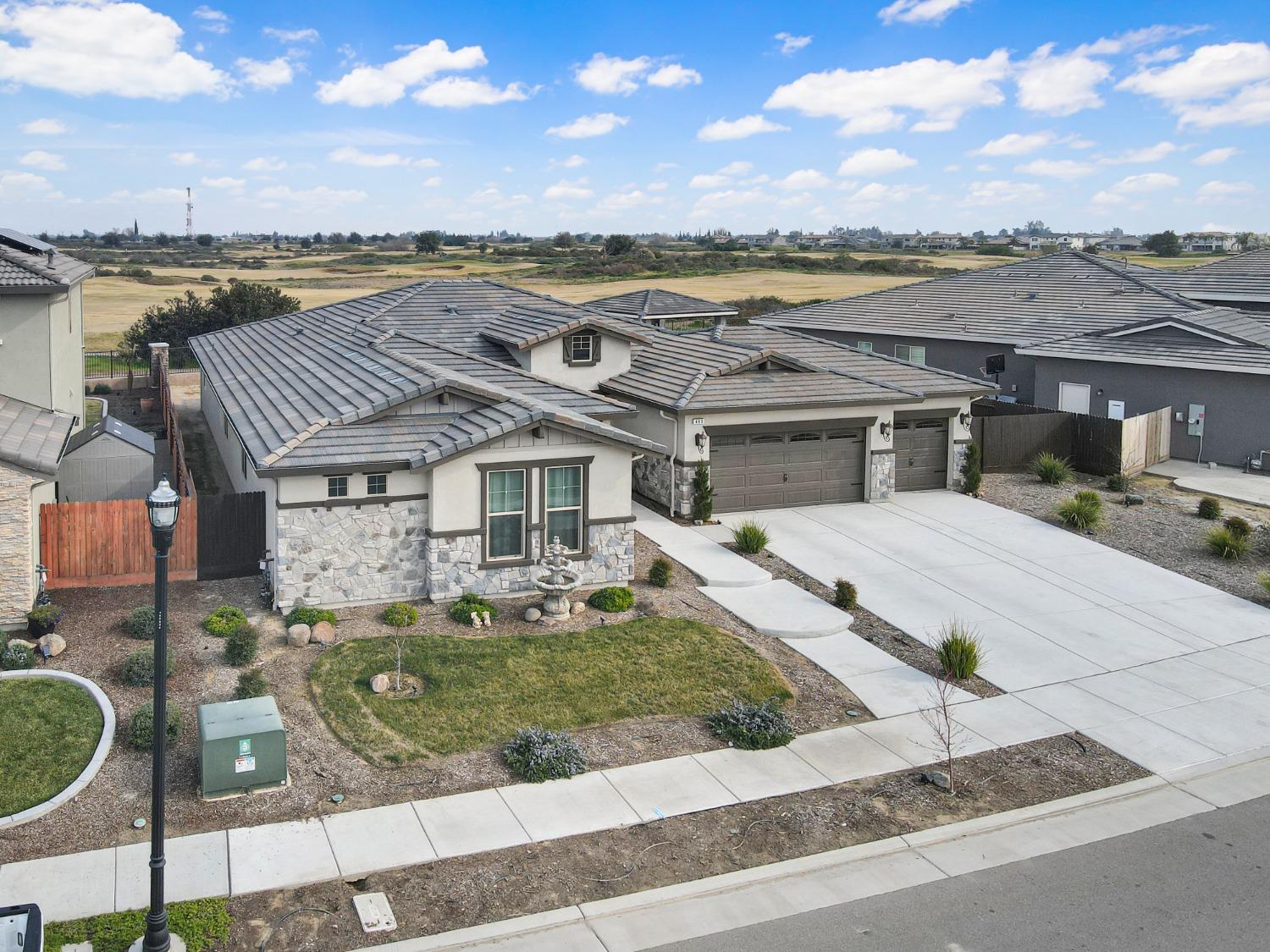 400 Ridge Creek Estates Way Dinuba, CA 93618 - Photo 42 of 49 an aerial view of a house with a yard