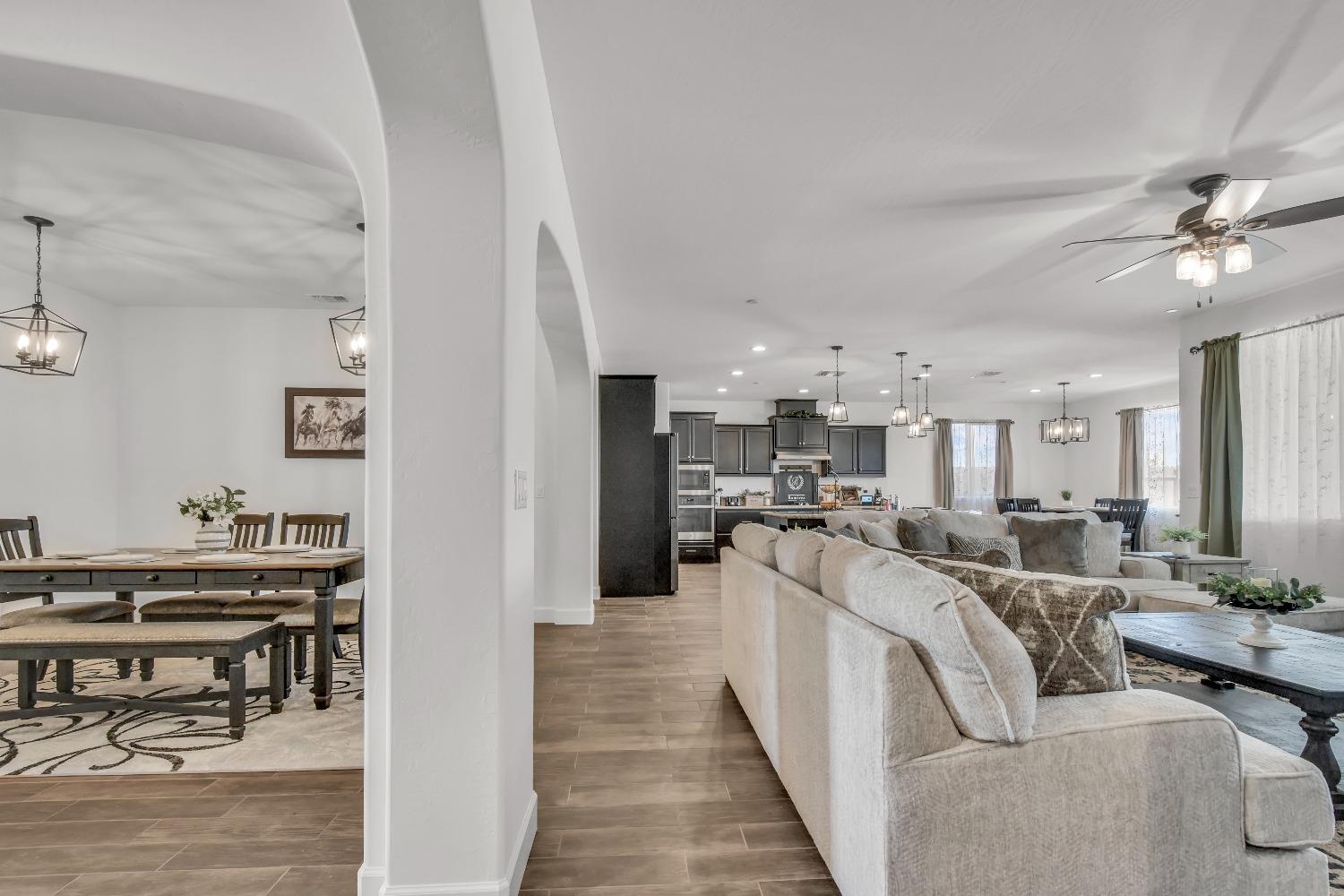 400 Ridge Creek Estates Way Dinuba, CA 93618 - Photo 8 of 49 a living room with lots of furniture and kitchen view