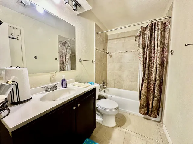 a bathroom with a sink toilet double vanity and shower