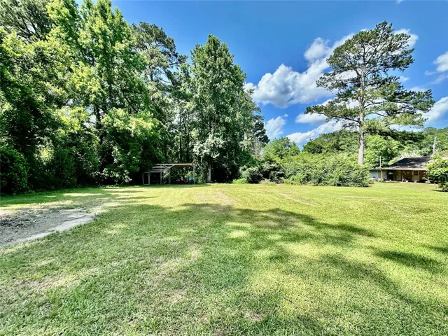 a view of yard with swimming pool