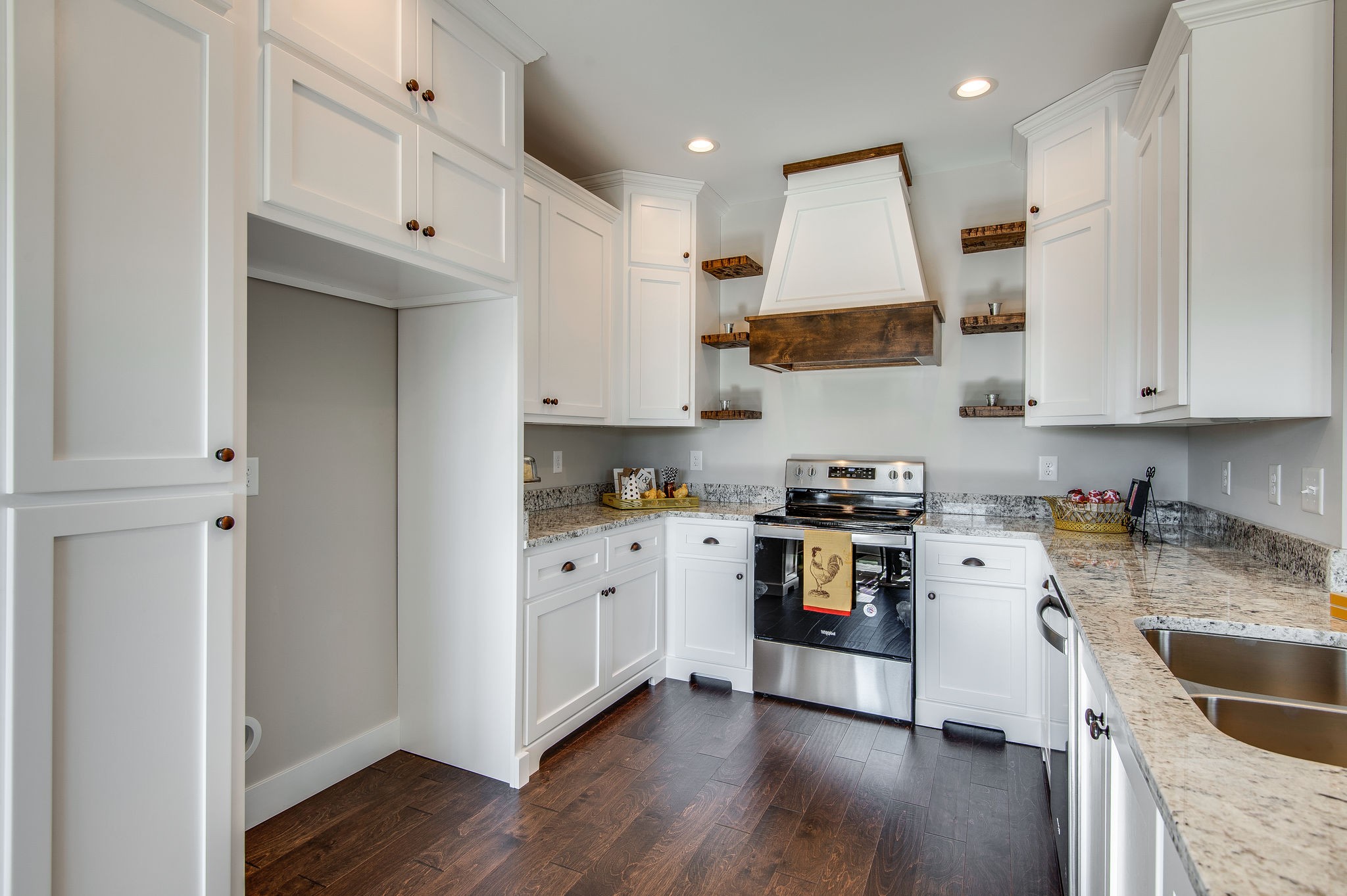 1026 Hayshed Road Dickson, TN 37055 - Photo 5 of 30 a kitchen with stainless steel appliances granite countertop a stove top oven a sink and white cabinets