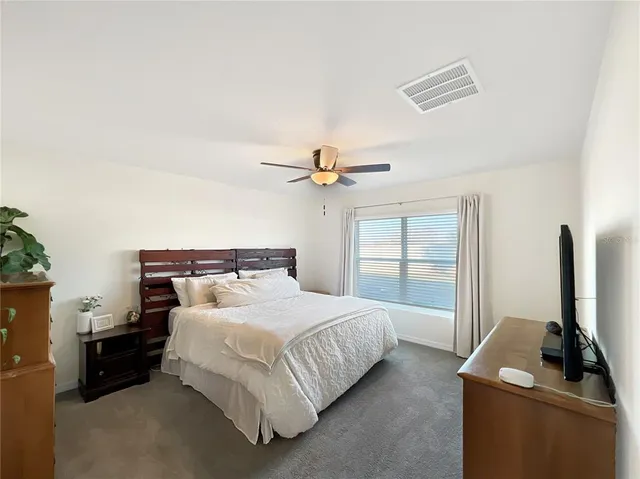 a bedroom with a bed and a flat tv screen