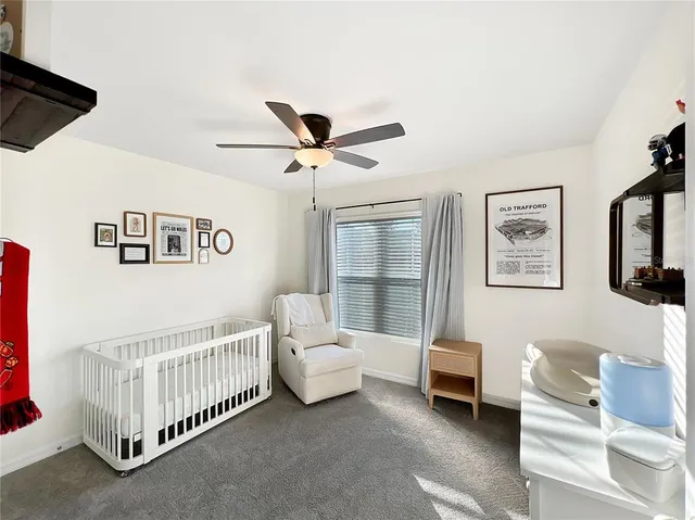 a living room with furniture and a baby crib