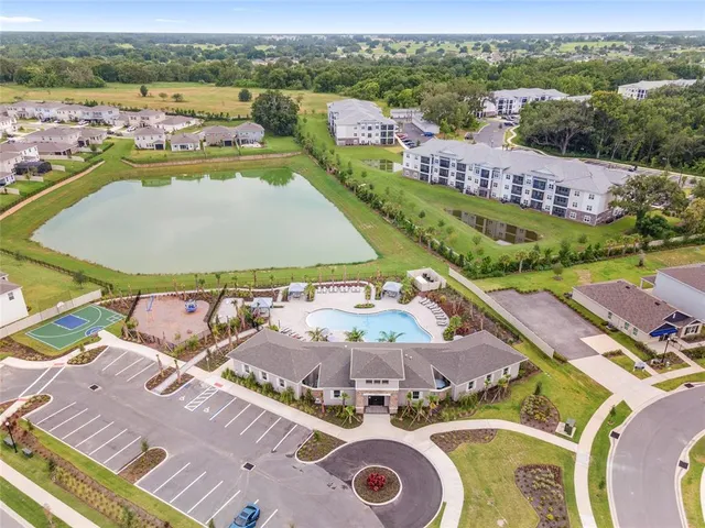 an aerial view of a house with a swimming pool yard and outdoor seating