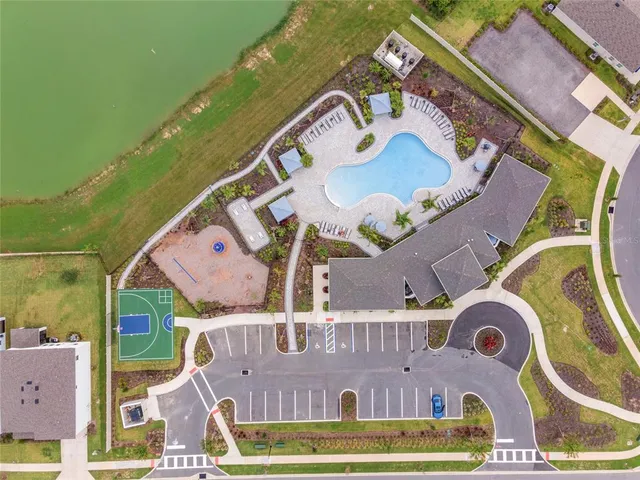 an aerial view of a house a yard and signage
