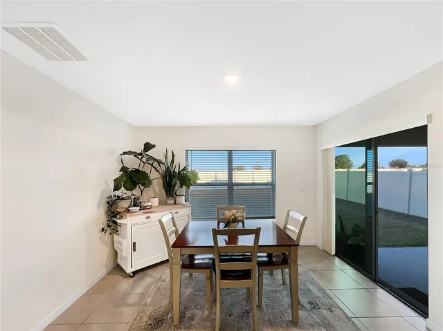 a view of a workspace room with wooden floor and a potted plant