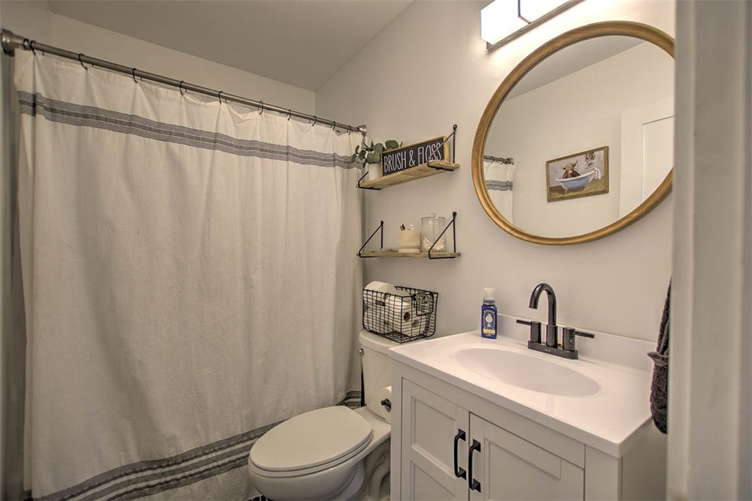 6 2nd South Shores Avenue Decatur, IL 62521 - Photo 16 of 24 a bathroom with a sink toilet and a mirror