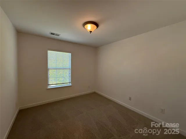 an empty room with a empty space and a window