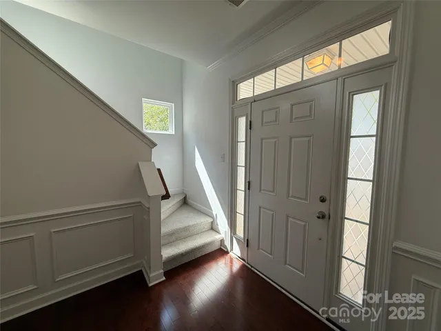 a view of front door with wooden floor