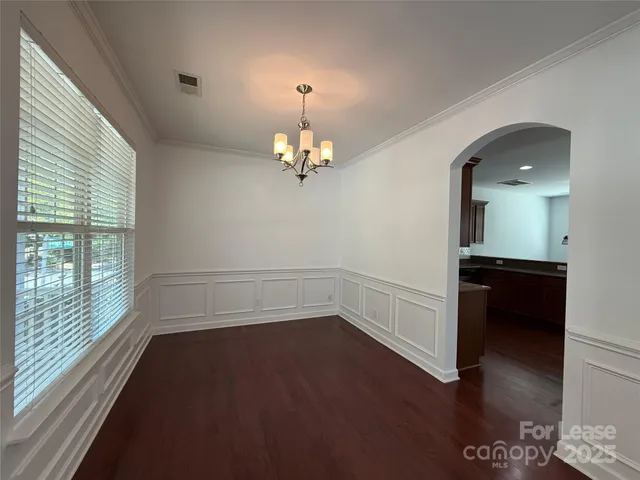 a view of a room with wooden floor and a large window