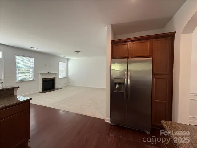 a kitchen with a refrigerator and a stove top oven